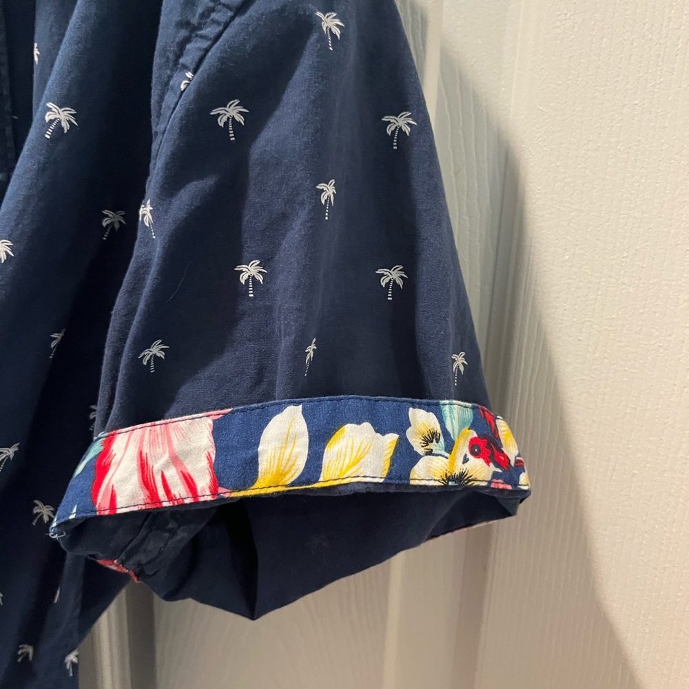 Navy blue aloha shirt with palm tree print and Hawaiian floral sleeve option